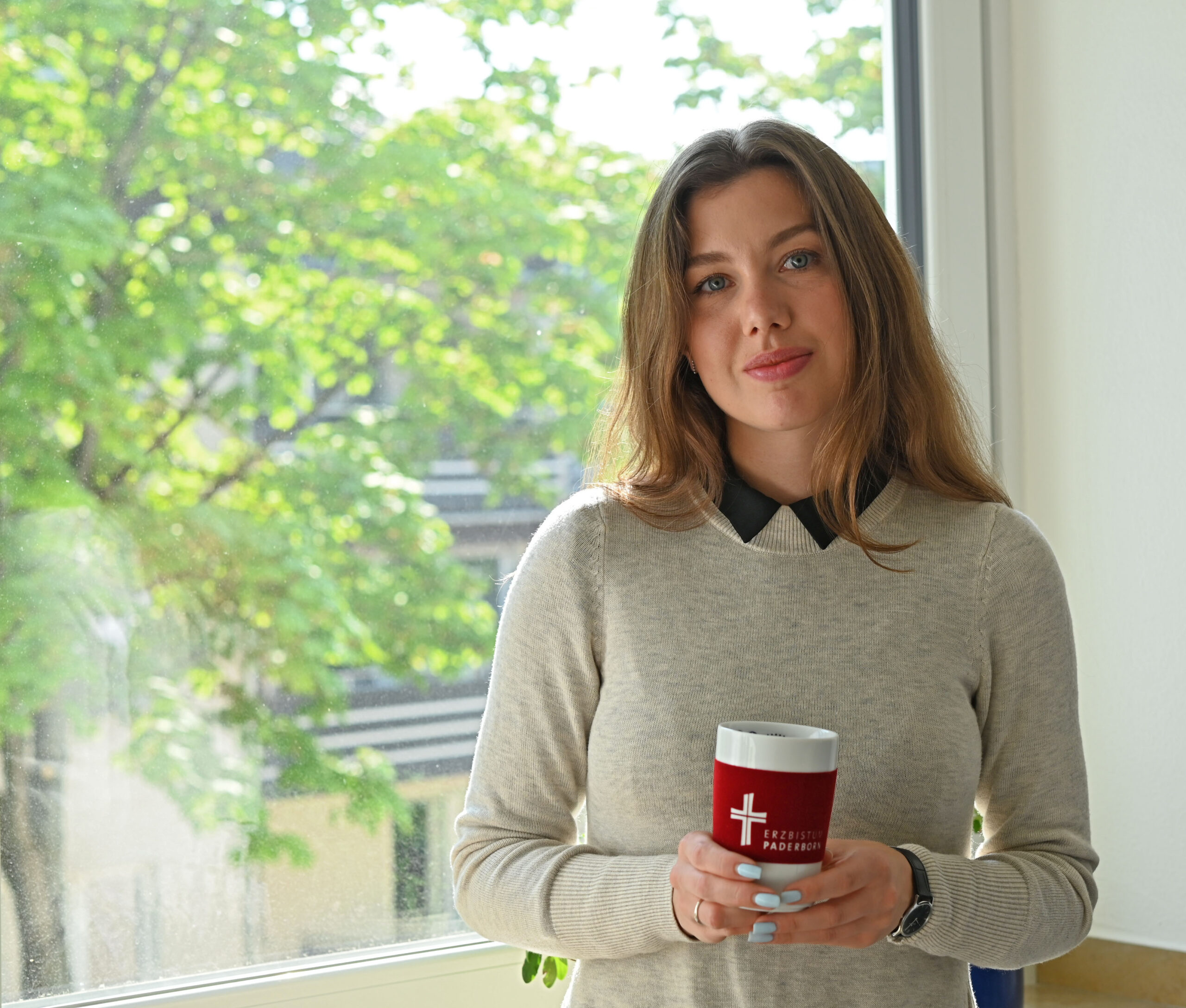 Sofiia Mumber mit einem Kaffeebecher in der Hand